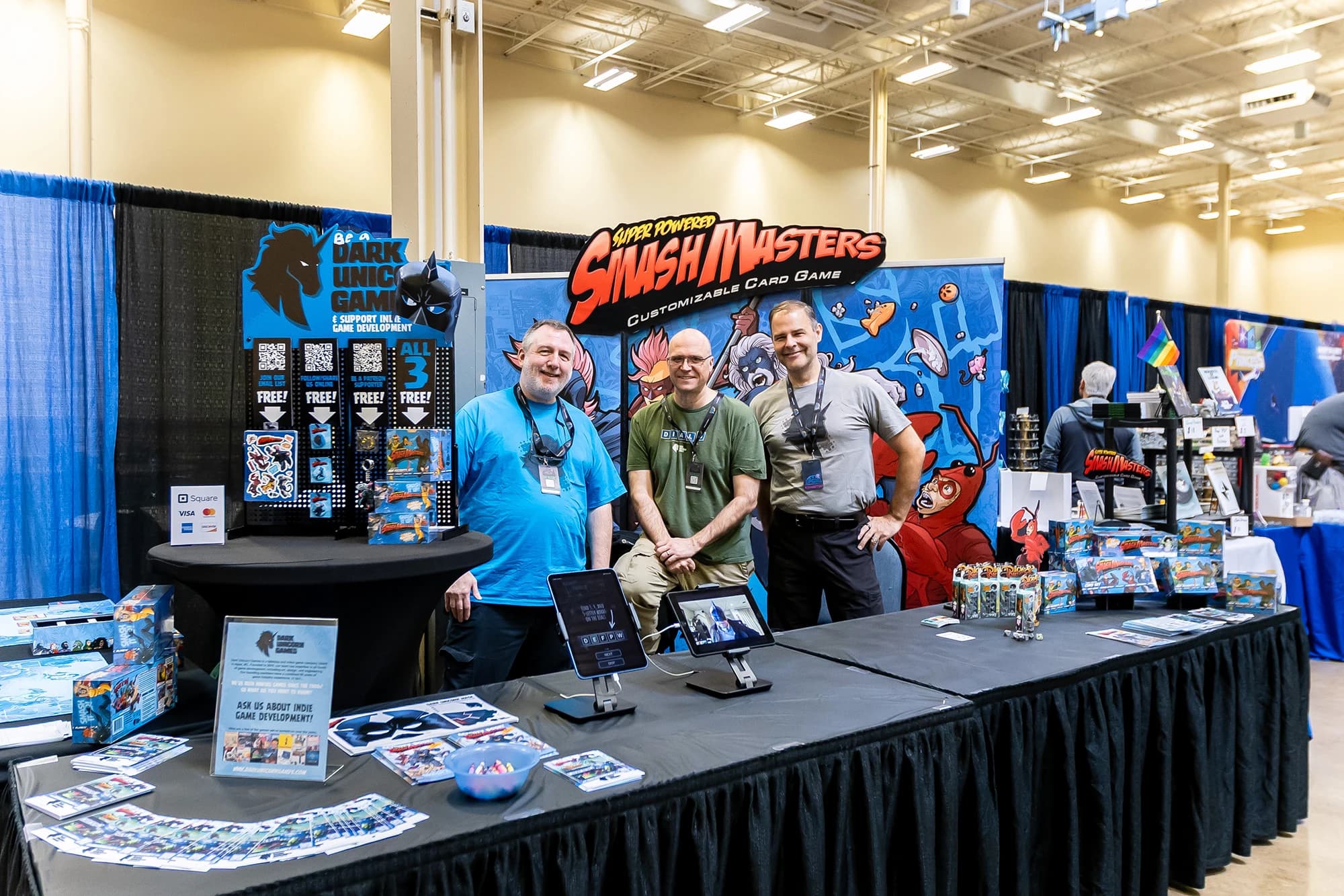 MCC Pittsburgh Gaming Expo exhibitor booth with visitors at convention center