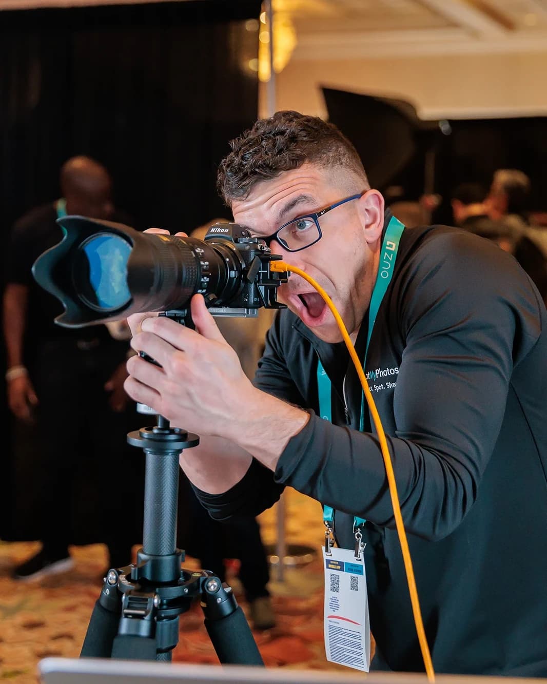 Planner reviewing headshot lounge setup at corporate conference