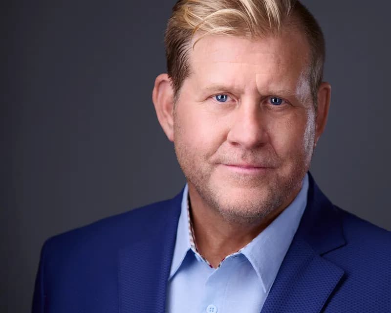 Executive male headshot example in a tailored suit