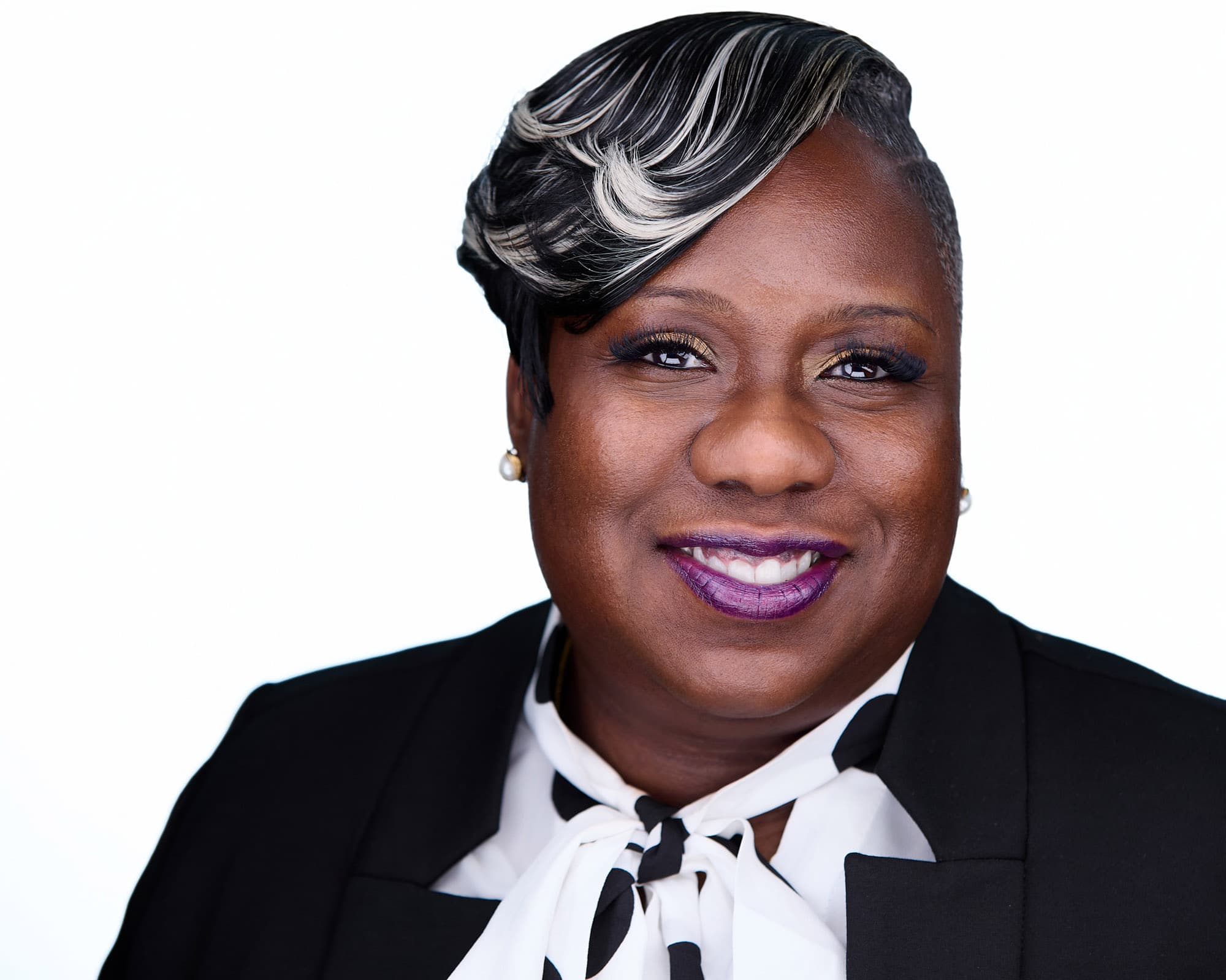 Business woman headshot in a jewel-tone outfit