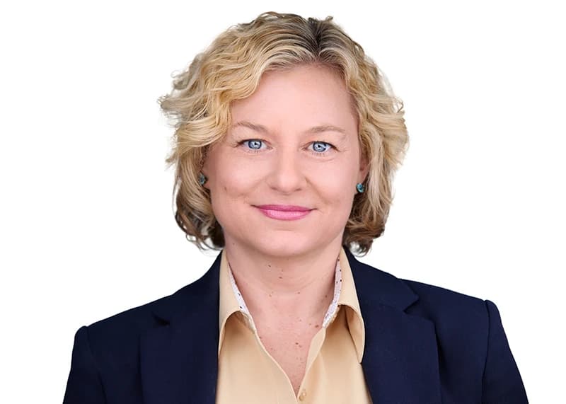 Professional headshot on white background - woman in navy blazer