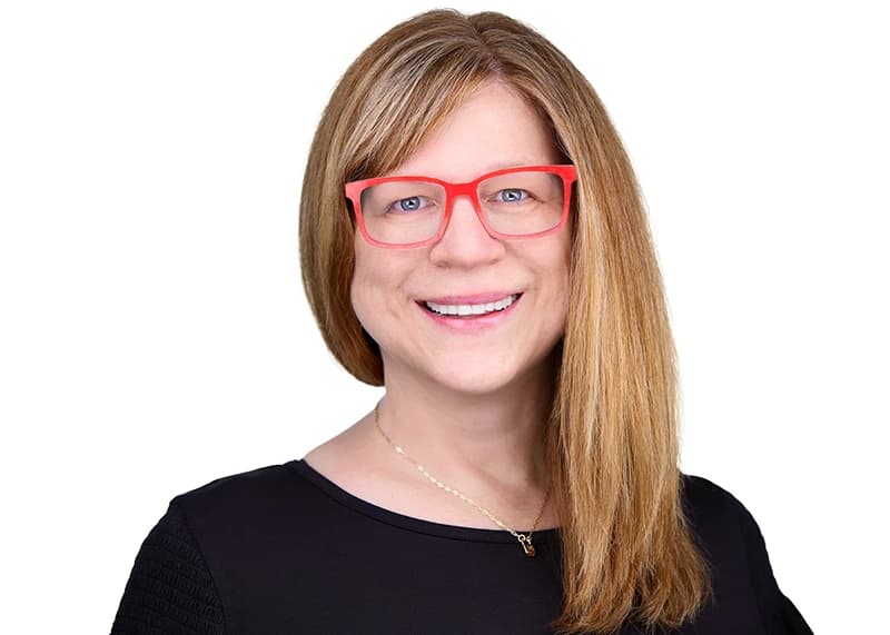 Professional headshot of woman wearing glasses