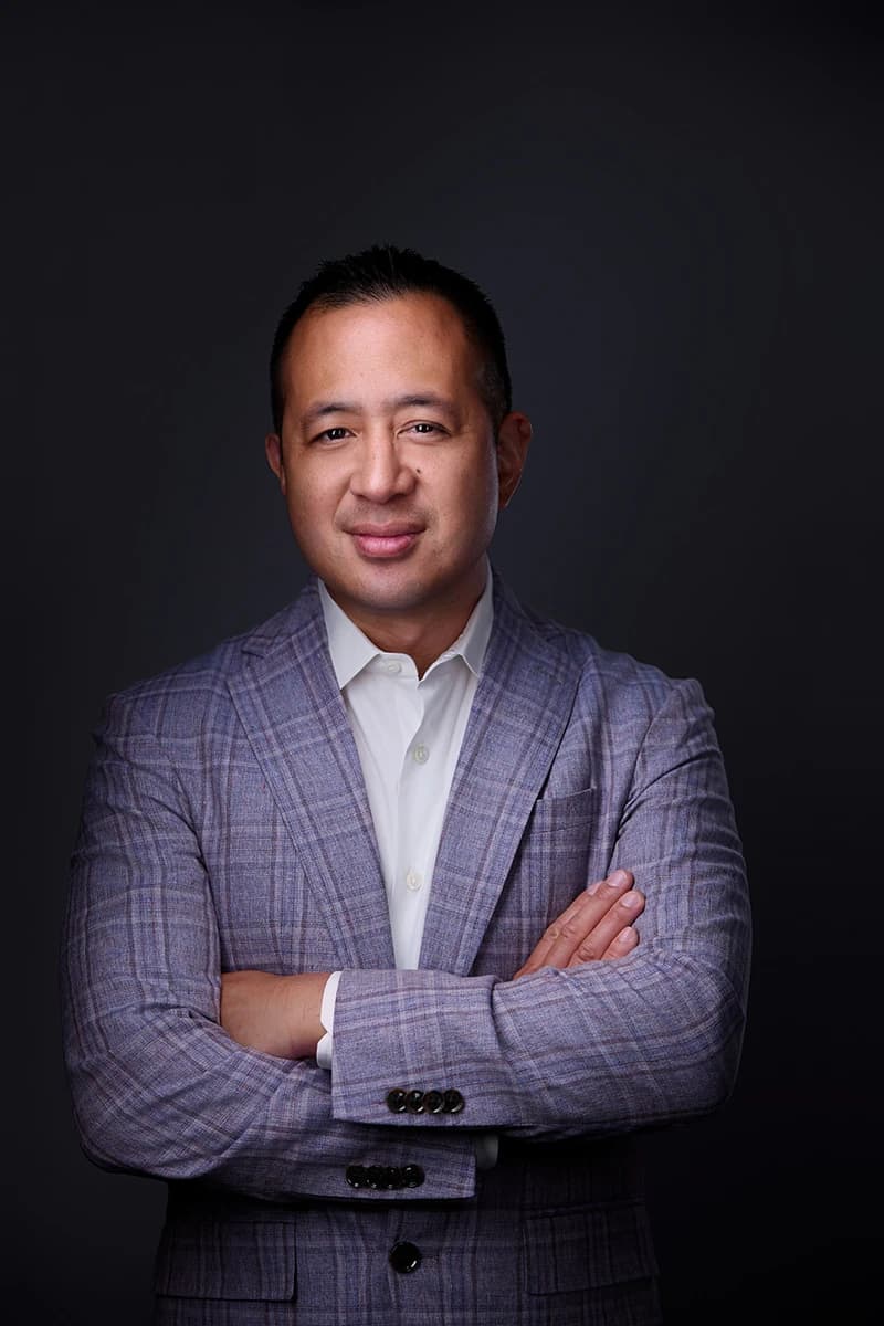 Professional headshot showing light plaid blazer