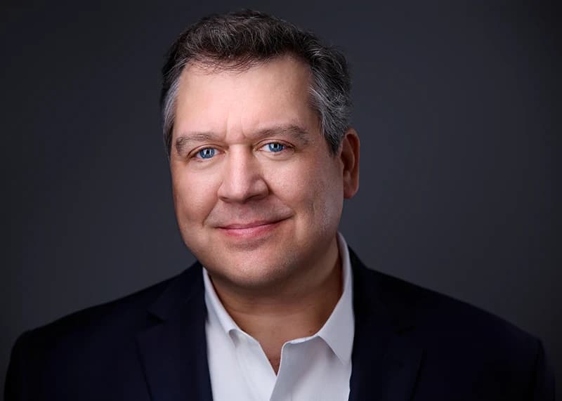 Professional headshot with serious expression