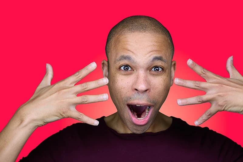 Professional headshot with red background