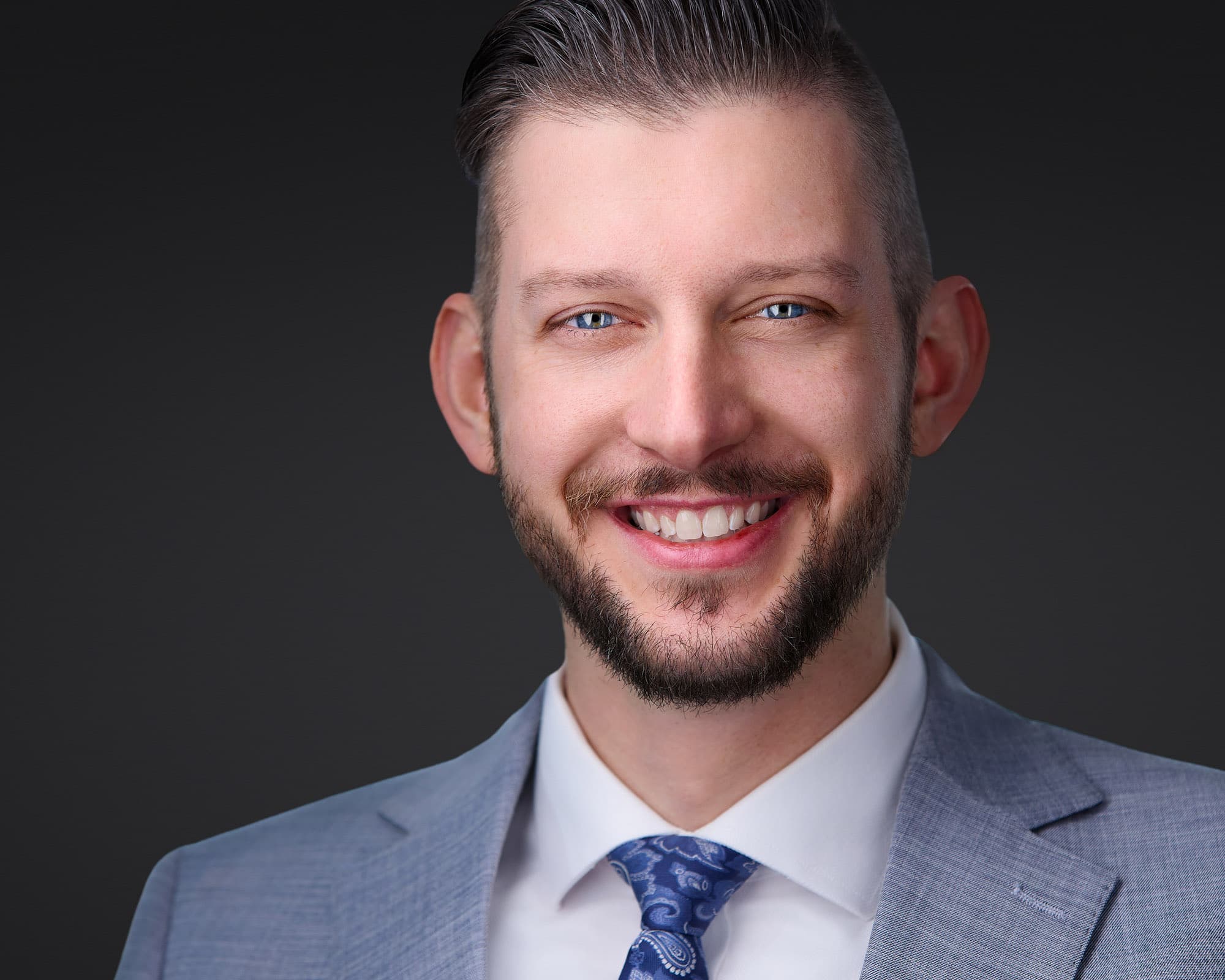 Executive male headshot example in a tailored suit