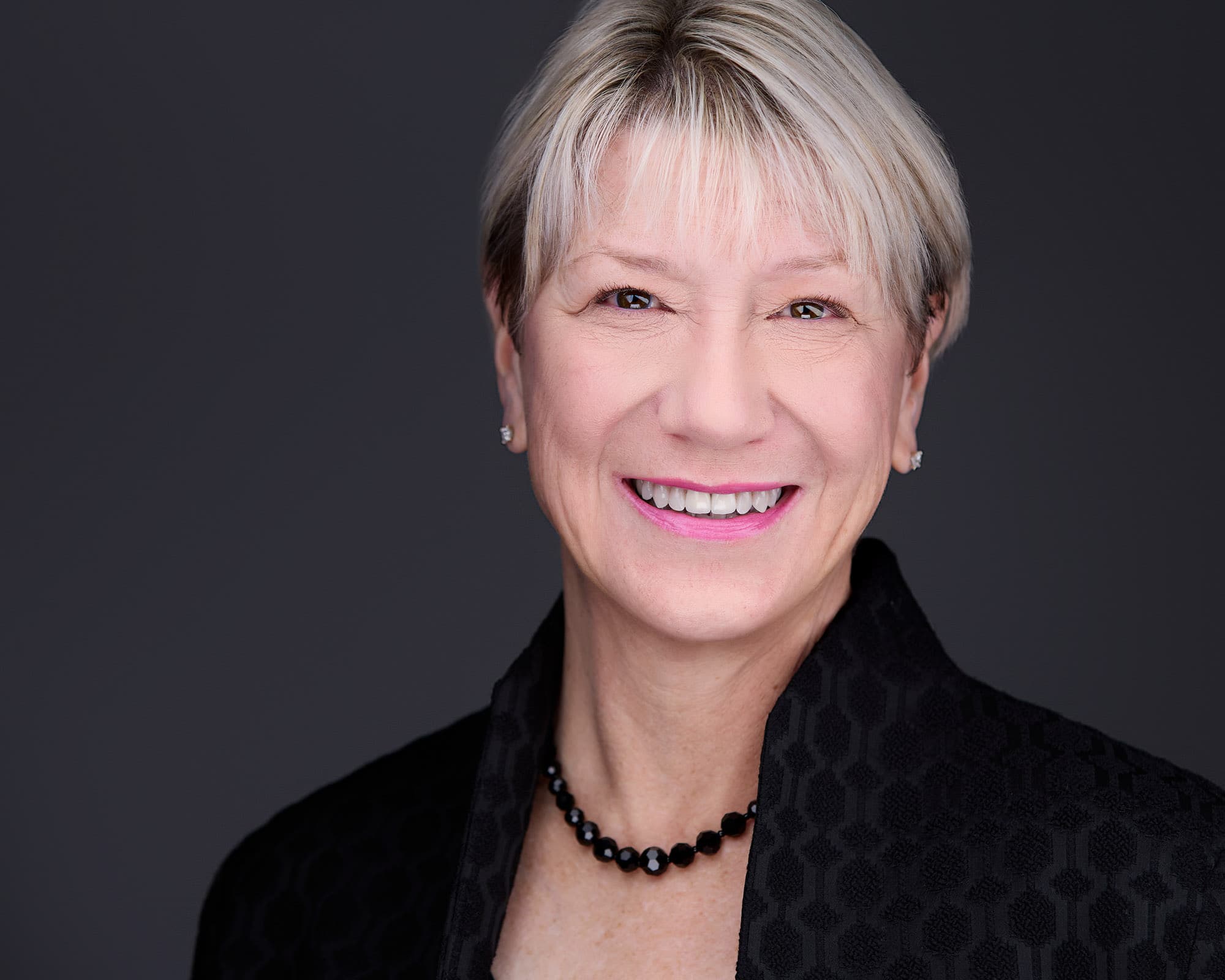 Executive headshot of woman with silver hair