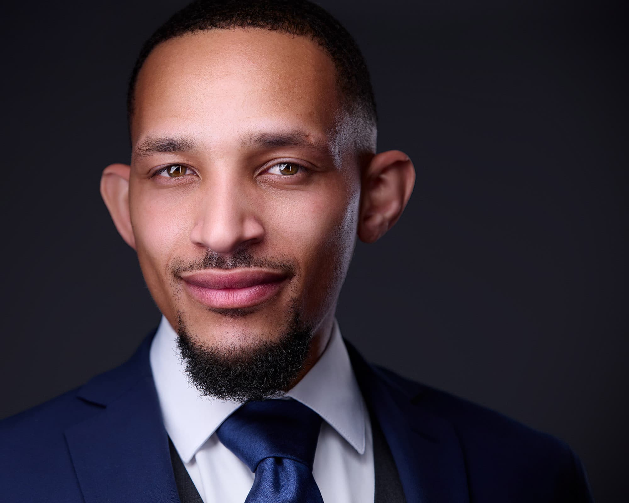 Headshot tips for men - professional executive in tailored suit