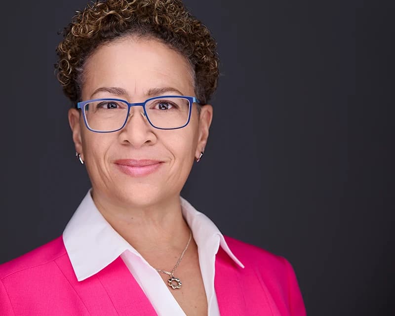Professional female headshots in a tailored business outfit