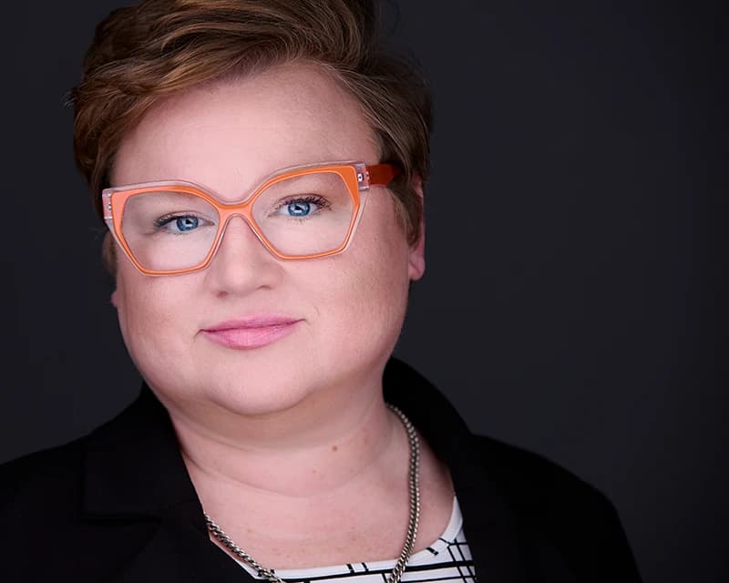 Professional woman headshot with styled professional hair