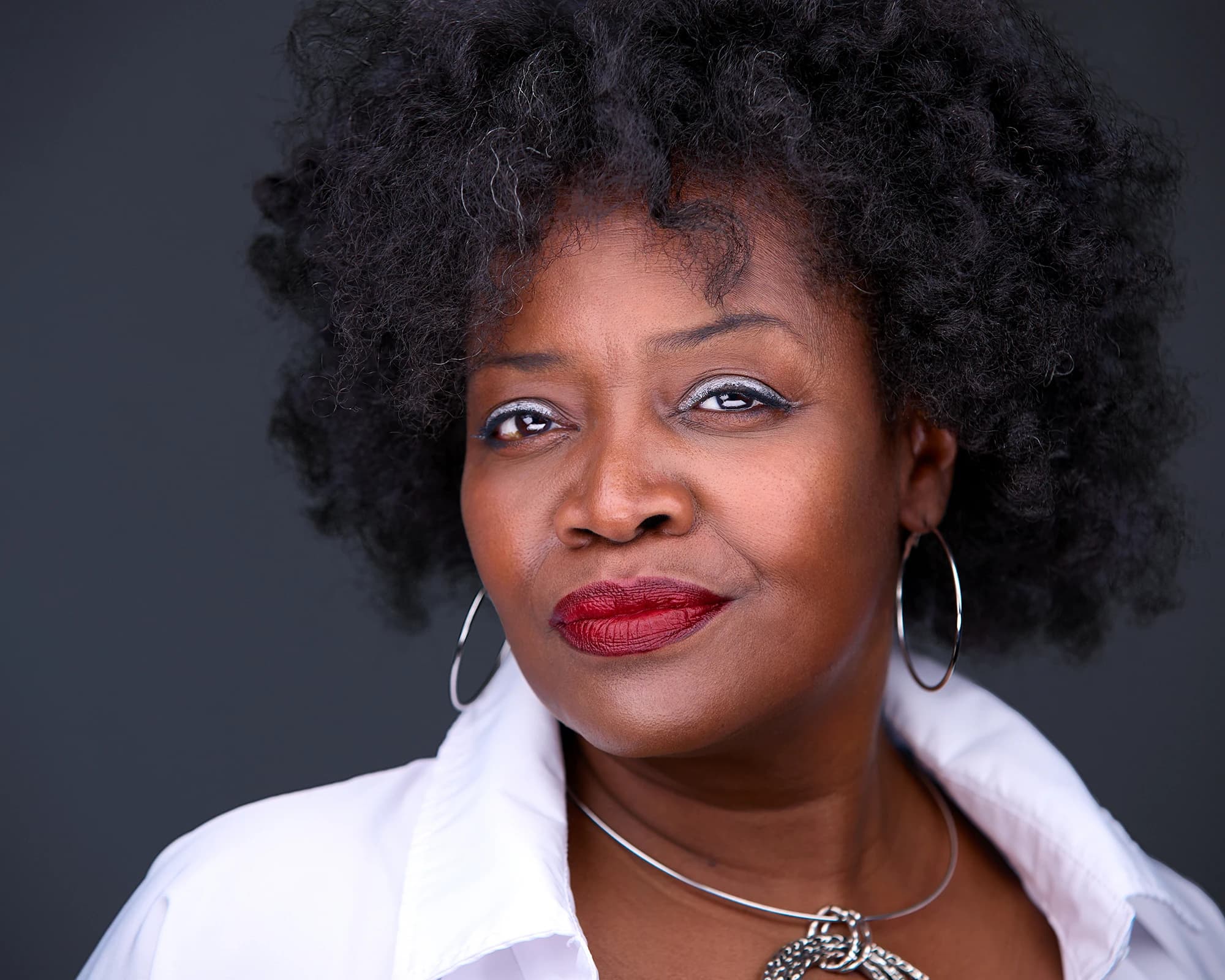 Natural curly hair worn down for a professional headshot