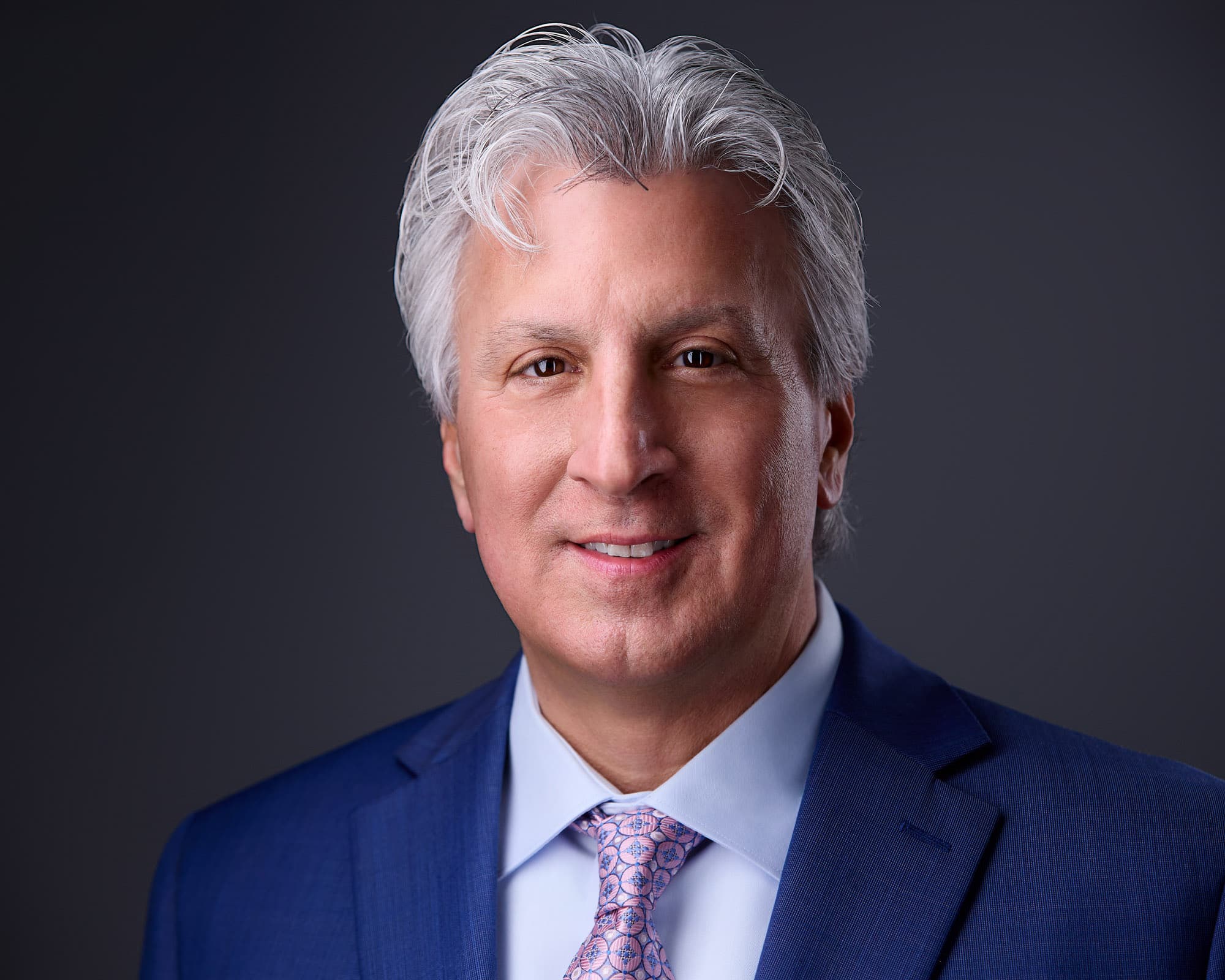 Well-fitted suit and collared shirt in a corporate executive headshot