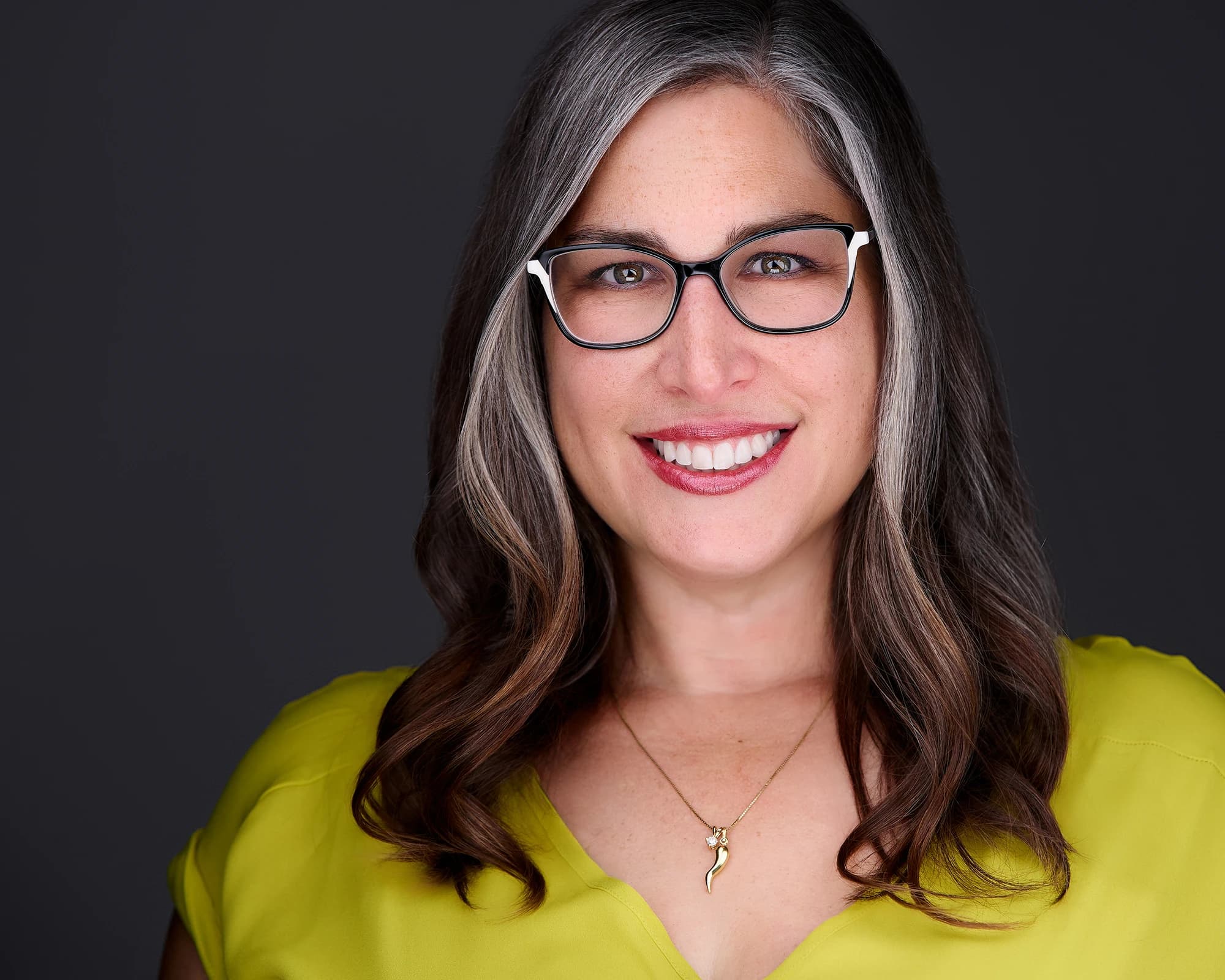 Smooth, settled hair framing the face in a corporate headshot