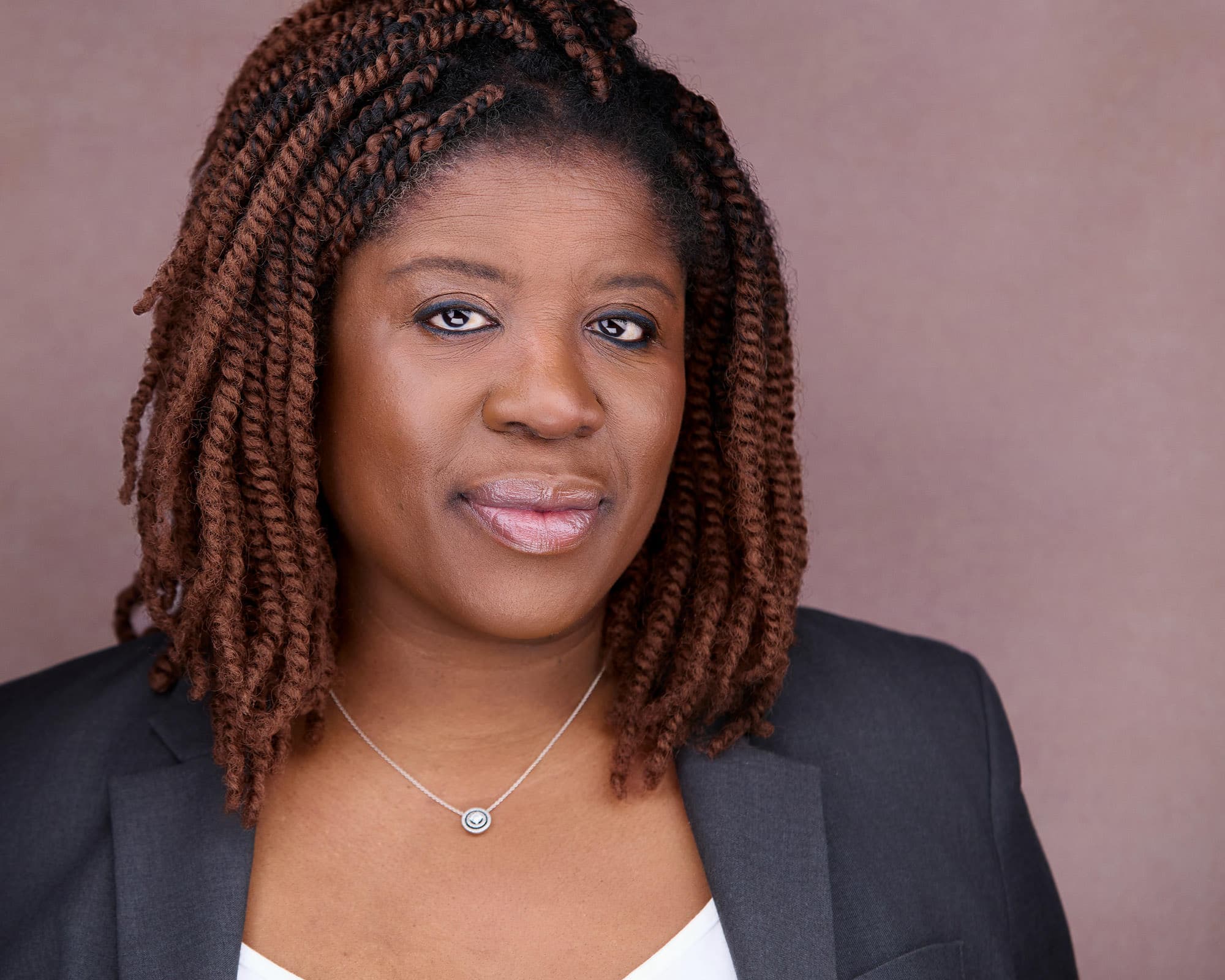 Professional female headshots in a tailored black blazer