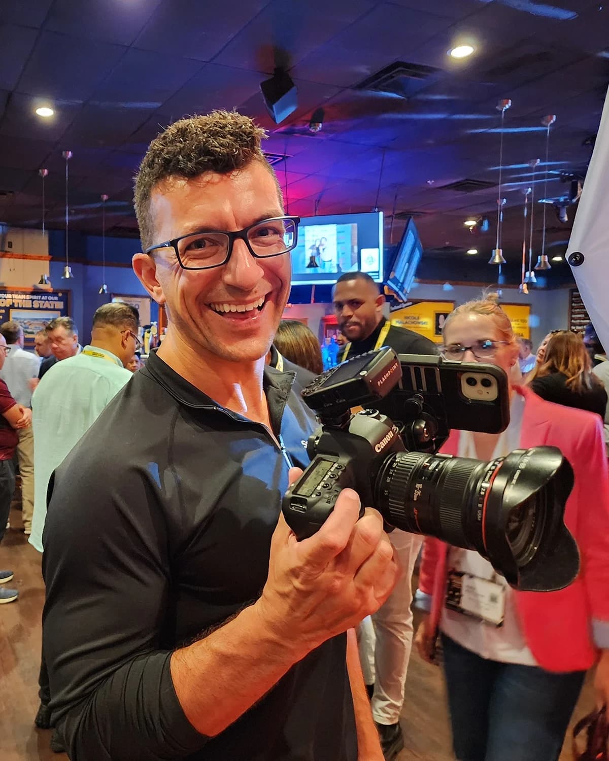 Chad Isaiah photographing attendees at evening convention event
