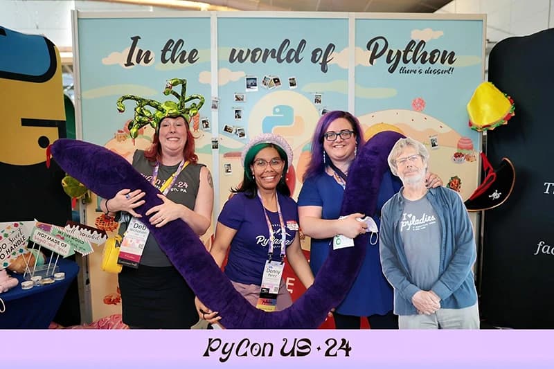 Event guests enjoying step and repeat photography experience at corporate function