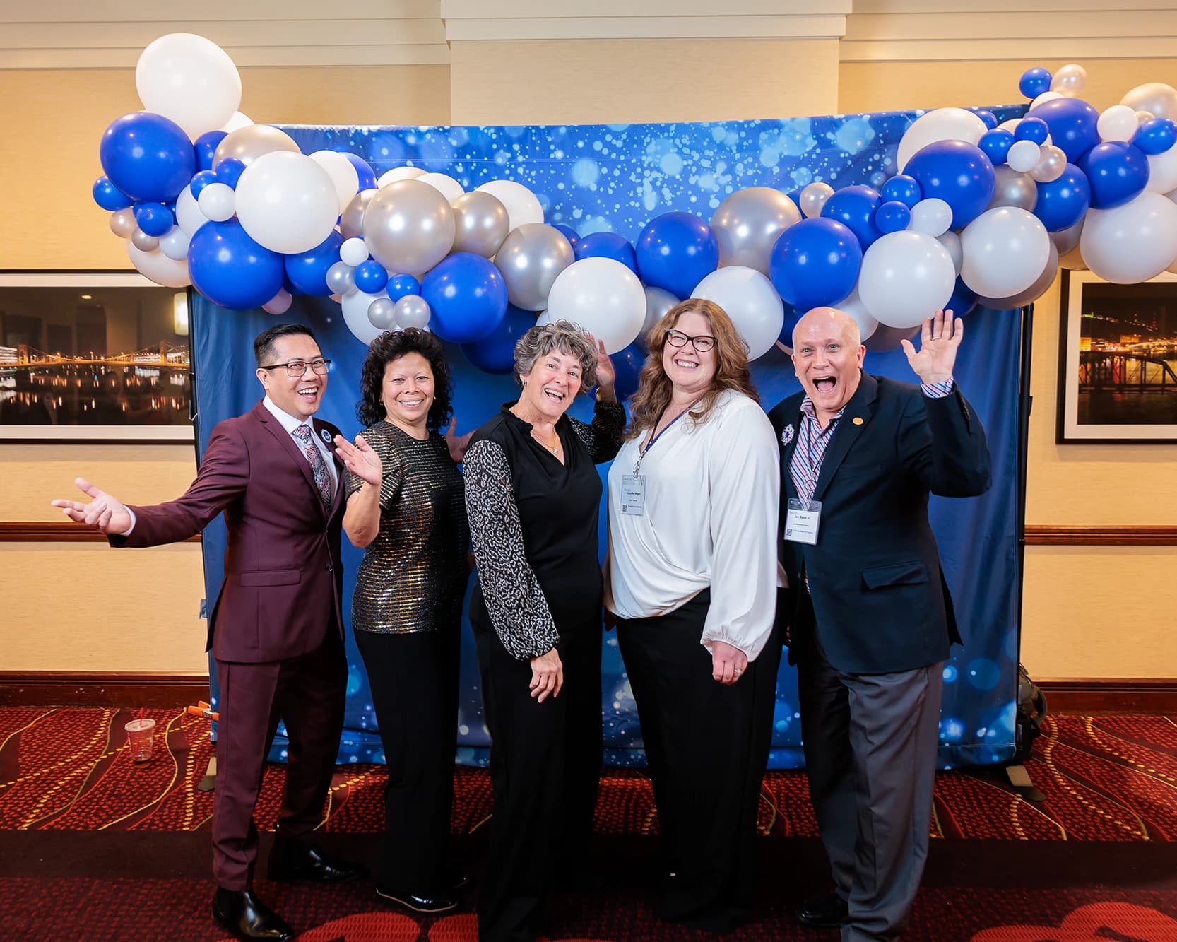 NCSBN conference attendees posing for step and repeat photography with branded banner