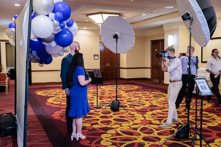 Pittsburgh step and repeat photography with guests posing in front of branded backdrop
